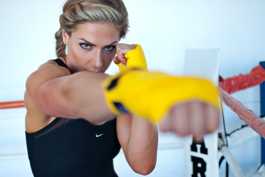 Boxer throwing a punch with yellow hand wraps